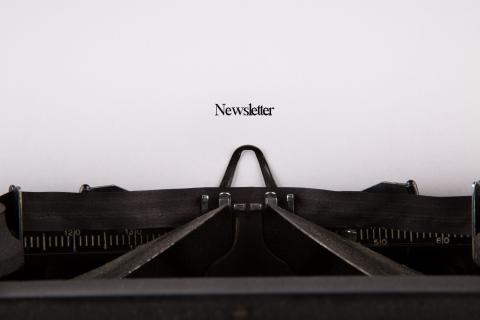 The word "Newsletter" typed on an old-fashioned typewriter